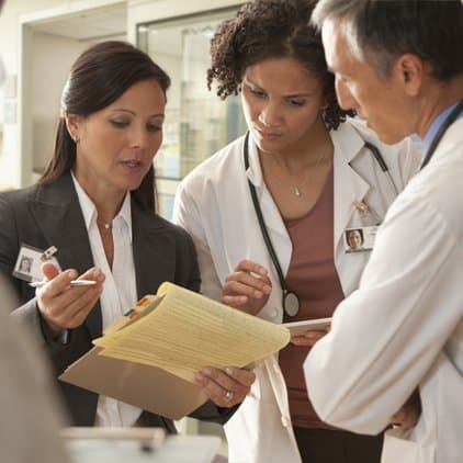 Doctors working with hospital administrator