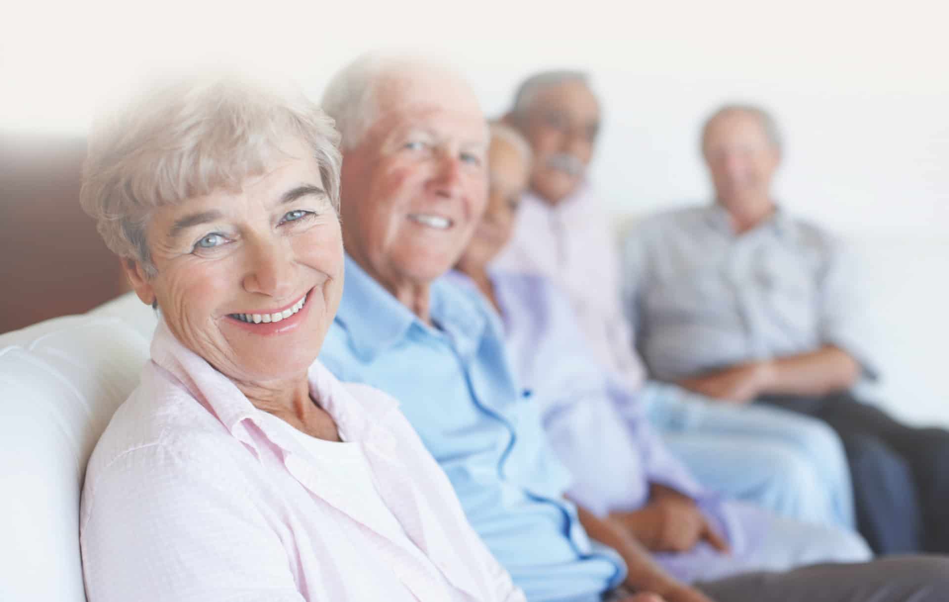 4 elderly people sitting on a couch